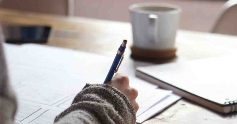 Picture of Person Writing in Notebook